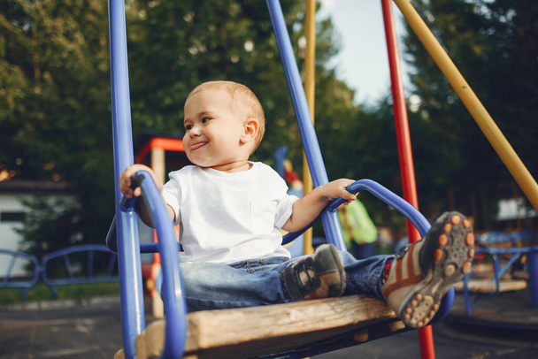 Cute little boy have fun on a playground - Fotó, kép