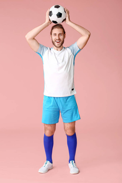 Happy football player on color background - Foto, Imagen