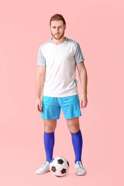 Male football player on color background - 写真・画像