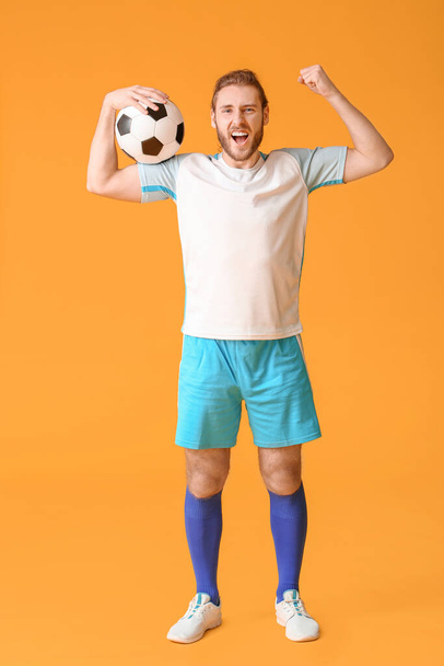 Happy football player on color background - Fotó, kép