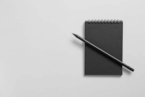 Notebook with pencil on grey background - Photo, Image