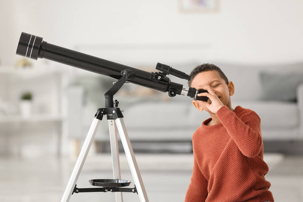 Little African-American boy with telescope at home - Foto, Imagen