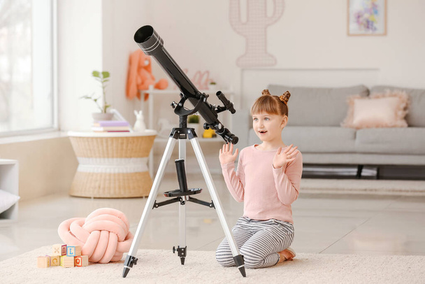 Cute little girl with telescope at home - Zdjęcie, obraz