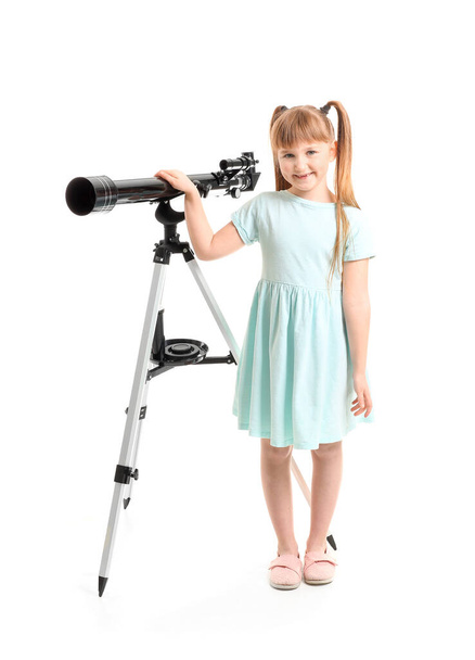 Cute little girl with telescope on white background - Photo, Image