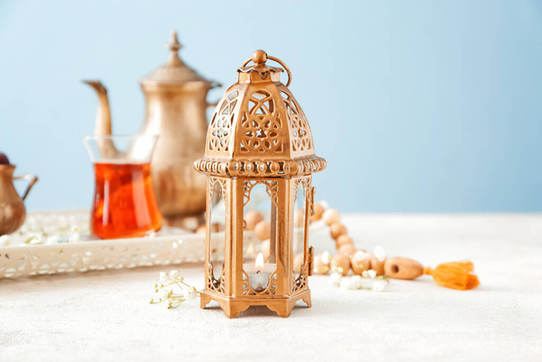 Lámpara musulmana con té sobre mesa blanca
 - Foto, Imagen