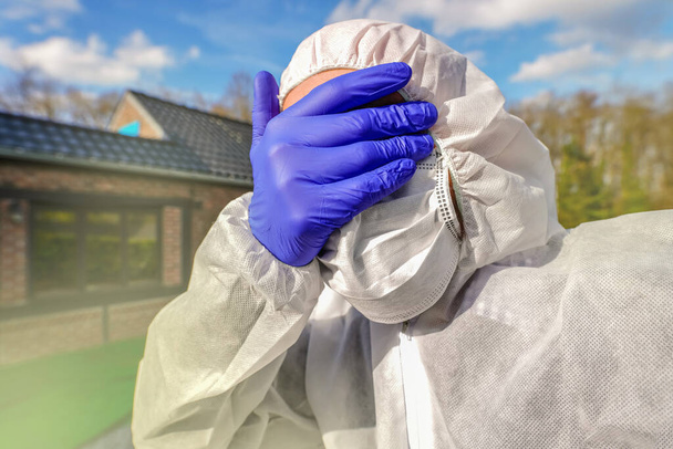 Doctor wearing antiviral protective surgical face mask and coveralls during Coronavirus pandemic worldwide crisis and lockdown in Europe, USA and China. Dangerous SARS-CoV-2 virus Epidemic. - Photo, Image