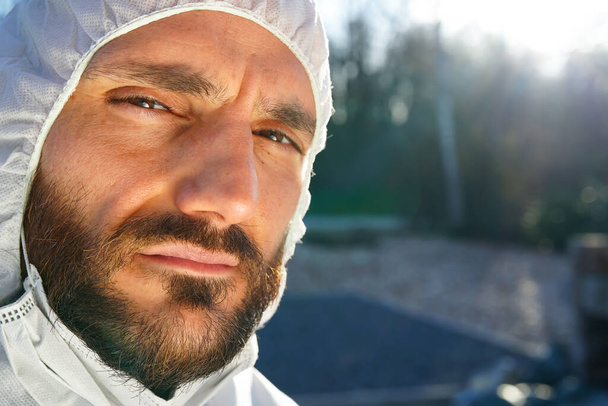 Врач носит противовирусную защитную хирургическую маску и комбинезон во время пандемии коронавируса в Европе, США и Китае. Опасный вирус атипичной пневмонии
. - Фото, изображение