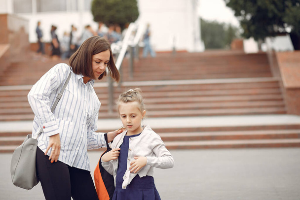Mother prepare little daughter to school - Foto, Imagen
