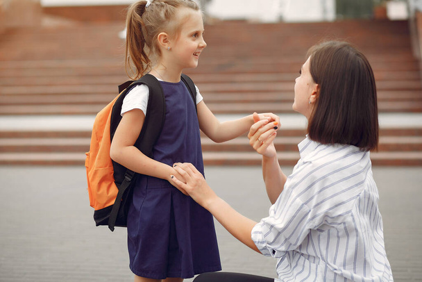 Mother prepare little daughter to school - Photo, image