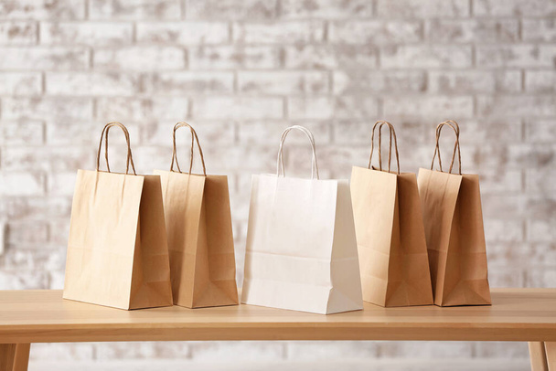 Many paper shopping bags on table - Valokuva, kuva
