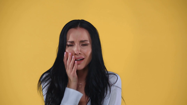 Beautiful worried businesswoman crying isolated on yellow - Felvétel, videó