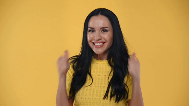 Opgewonden meisje tonen duimen omhoog en ja gebaren geïsoleerd op geel - Video