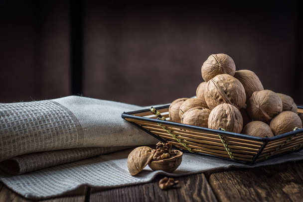 Walnuts on a wooden table and dark background - Foto, Imagem