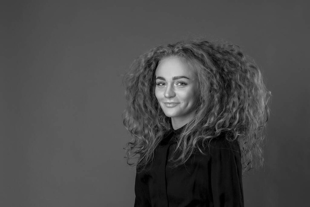 beautiful girl curly magnificent hair, in the studio, background - Valokuva, kuva