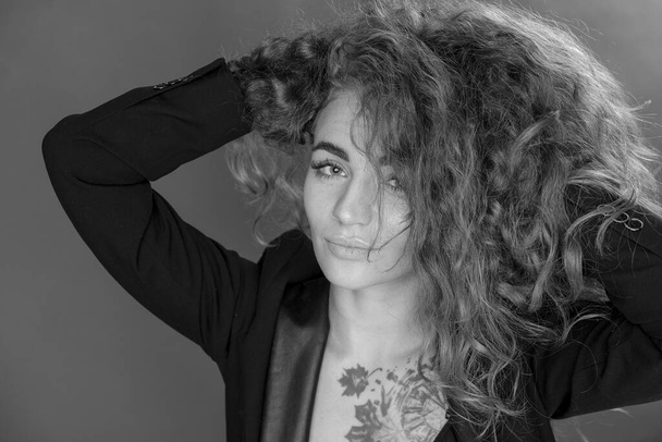 beautiful girl curly magnificent hair, in the studio, background - Φωτογραφία, εικόνα