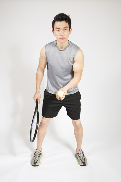 Man Holding a Tennis Racquet and Ball - Photo, Image