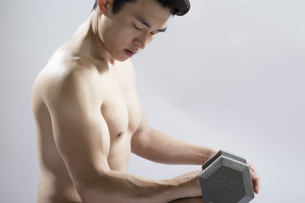 Athletic Male Lifting Weights - 写真・画像