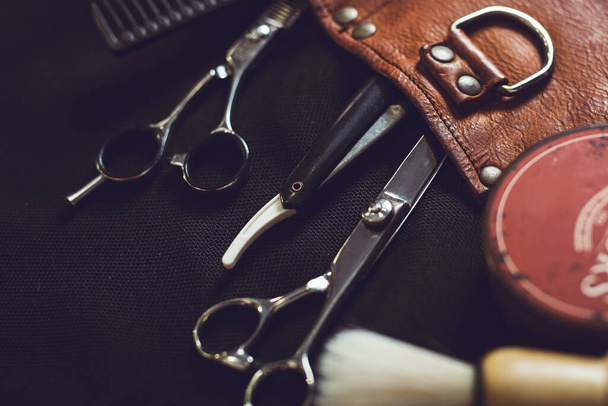 Barber shop equipment on Black background . Professional hairdressing tools.  - Fotografie, Obrázek