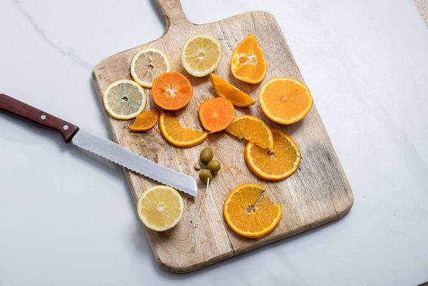 slices of orange and lemon on a chopping board - Zdjęcie, obraz