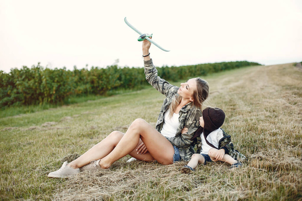 Mother with cute little son in a summer field - Fotografie, Obrázek