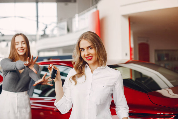 Two stylish women in a car salon - Foto, Imagen