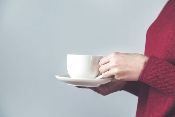 woman hand cup of coffee and tea on gray background - Фото, зображення
