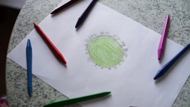 multicolored pencil drawing of coronavirus on a white sheet of paper top - Footage, Video