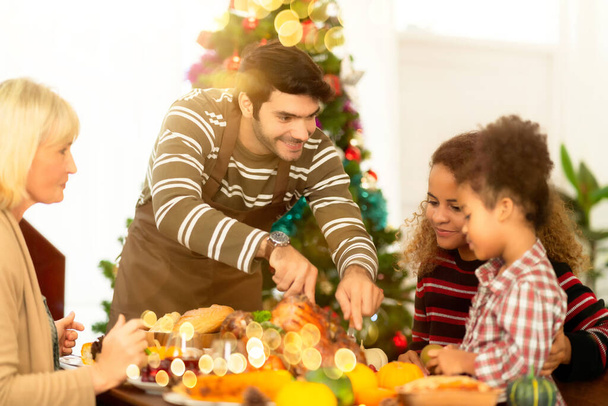 family having holiday dinner and cutting turkey Thanksgiving Celebration Tradition Family Dinner Concept - Foto, imagen