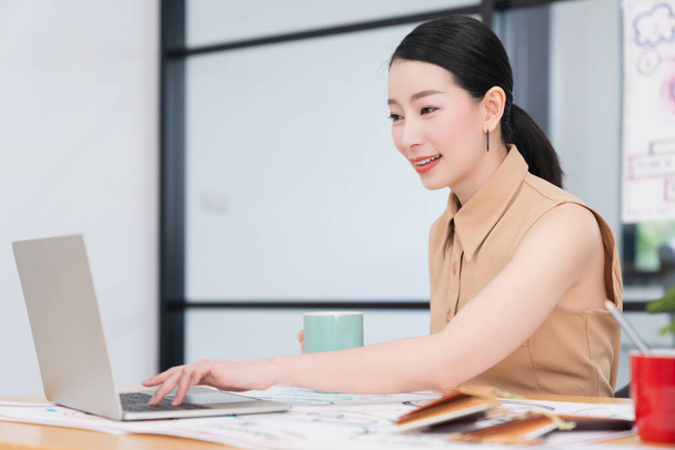 successful leadership smart attractive asian female working with laptop confident and cheerful smile office background - Foto, imagen