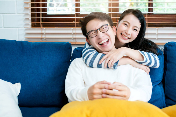 sweet lovey asian family couple sit talk good conversation on sofa in living room house background - Photo, image