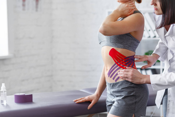 Weight loss concept.Kinesiology taping.Therapist applying kinesi - Фото, изображение