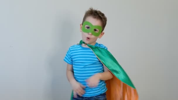 Portrait of a strong confident boy in a superhero costume Looking camera. success concept. happy childhood. 4k video - Felvétel, videó
