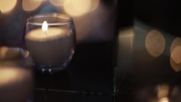 candles burning in tall glass candlestick, a restaurant, banquet, decoration, candles at the wedding table, decorative candles are lit on the festive table, close-up - Filmagem, Vídeo