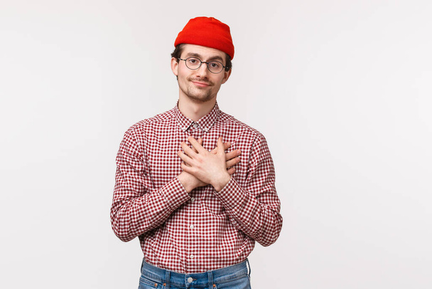Waist-up portrait funny and cute young male with moustache, smile touched and look grateful camera as touch heart, being delighted with sweet sincere praises and warm words, white background - Photo, Image