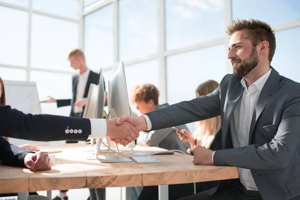 business colleagues shaking hands with each other at the meeting. - Photo, Image