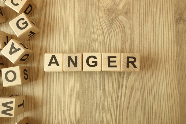 Word anger from wooden blocks on desk - Photo, Image