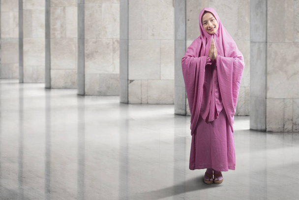 Asian Muslim woman in veil praying inside the mosque - Фото, изображение