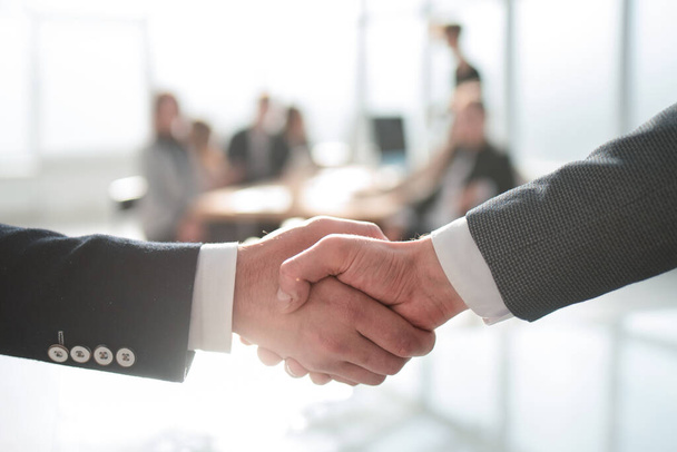 close up. handshake of business people on an office background - Фото, изображение