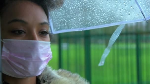 Zeitlupenaufnahme einer Südafrikanerin, die in der Öffentlichkeit eine schützende Gesichtsmaske trägt und an der Kamera vorbeiläuft - Filmmaterial, Video