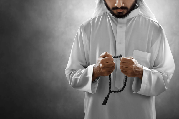 Religious arab muslim man praying with rosary beads - Fotoğraf, Görsel