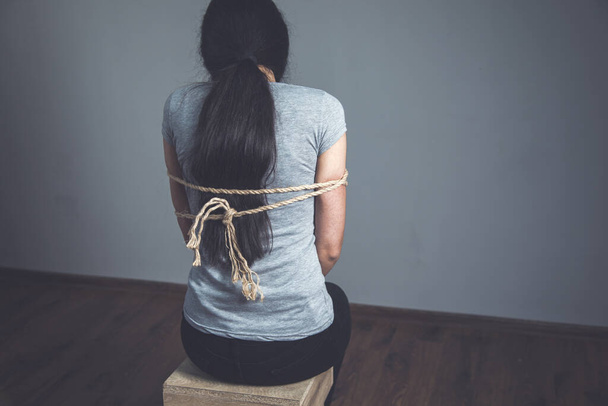 tied with rope sad woman on the dark background - Φωτογραφία, εικόνα