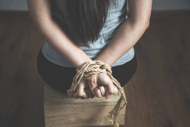 tied with rope sad woman on the dark background - Zdjęcie, obraz