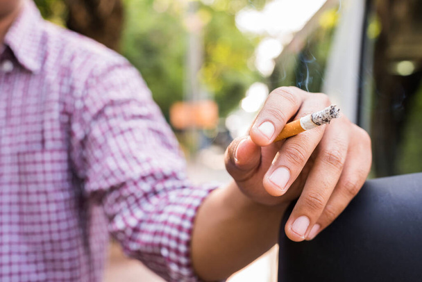 Close up young man smoking a cigarette. - Valokuva, kuva