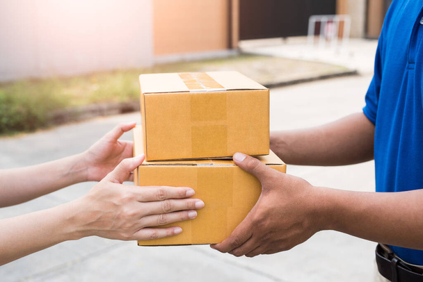 Women hands receiving package from delivery man. - Photo, Image