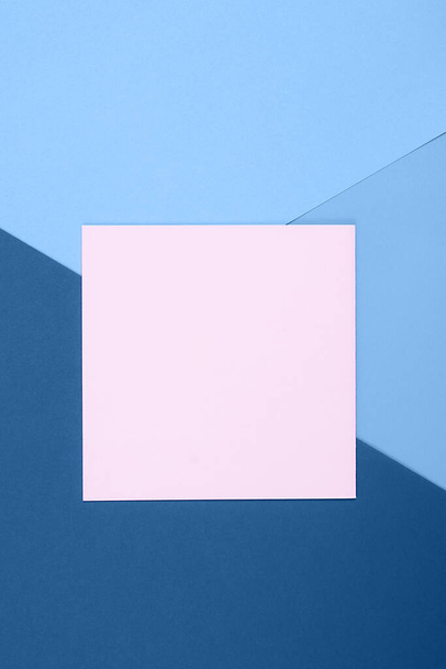 Blue background. Flat lay with ,blue colors and empty pastel pink blank. Flat lay for your design. Trendy colors. - Photo, Image