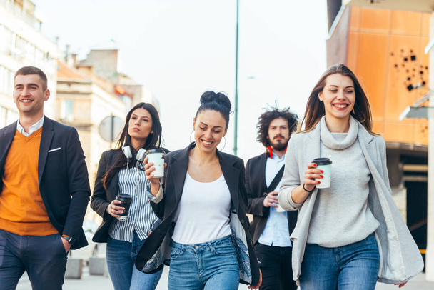 Friends Bonding, group of multi-ethnic friends walking on the streets talking to each other and smiling - Φωτογραφία, εικόνα