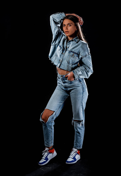 Studio body shot of a fashion female model posing in modern clothing - Foto, Bild