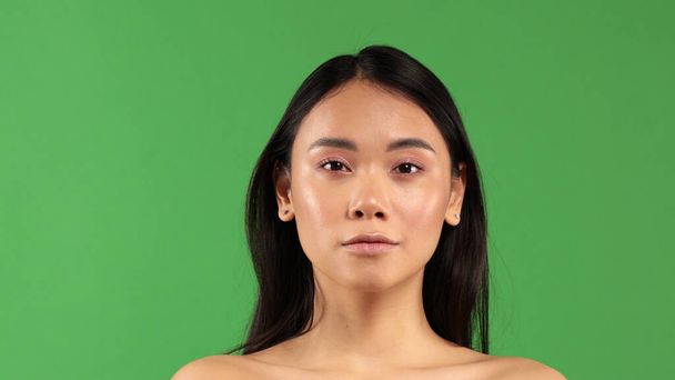 Closeup face of young asian woman exterior with clear skin on isolated background - Фото, зображення