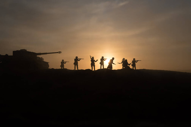 War Concept. Military silhouettes fighting scene on war fog sky background, World War Soldiers Silhouette Below Cloudy Skyline sunset. Selective focus - Fotó, kép