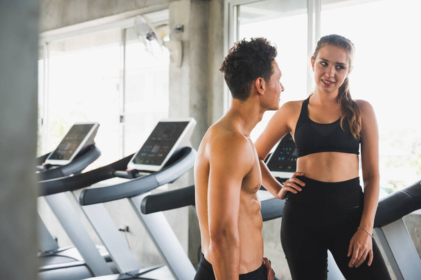 Lovers standing post Near the treadmill. Couple fitness workout together concept - Photo, Image
